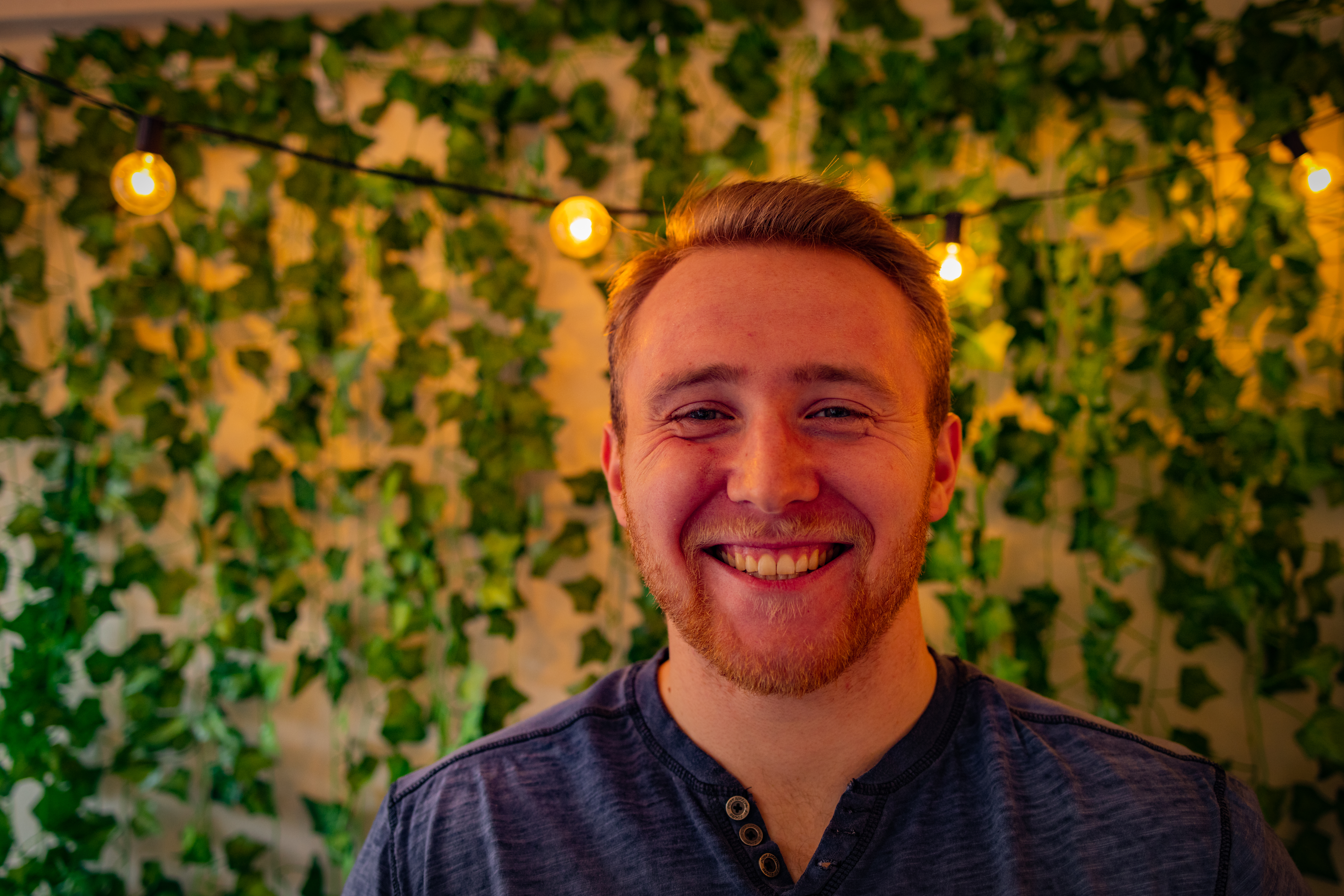 Drexel University's College of Nursing and Health Professions Health Sciences student Nicholas Eltman standing in front of an ivy covered wall.